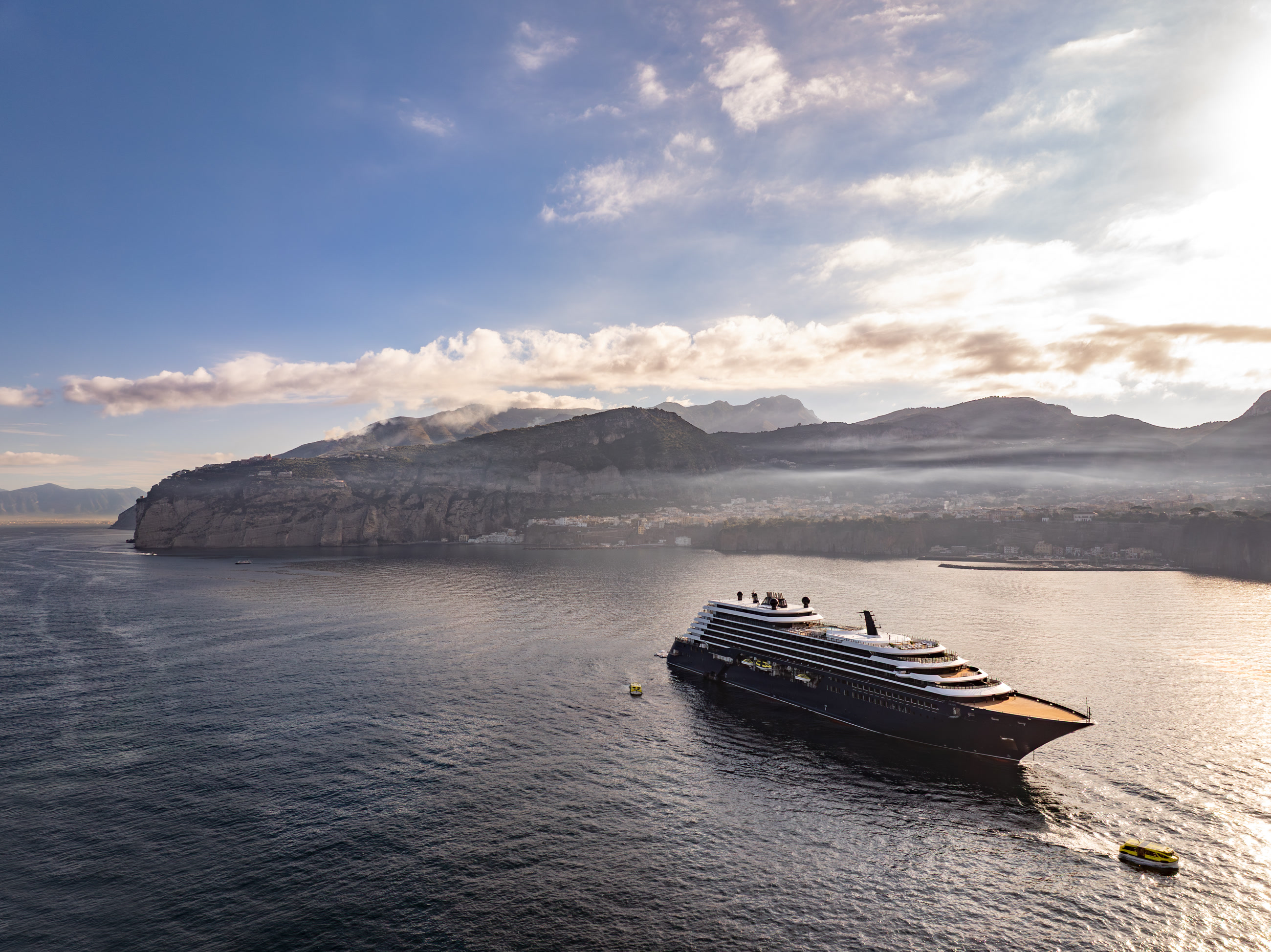 A luxury yacht sailing beneath the mountains of Sorrento