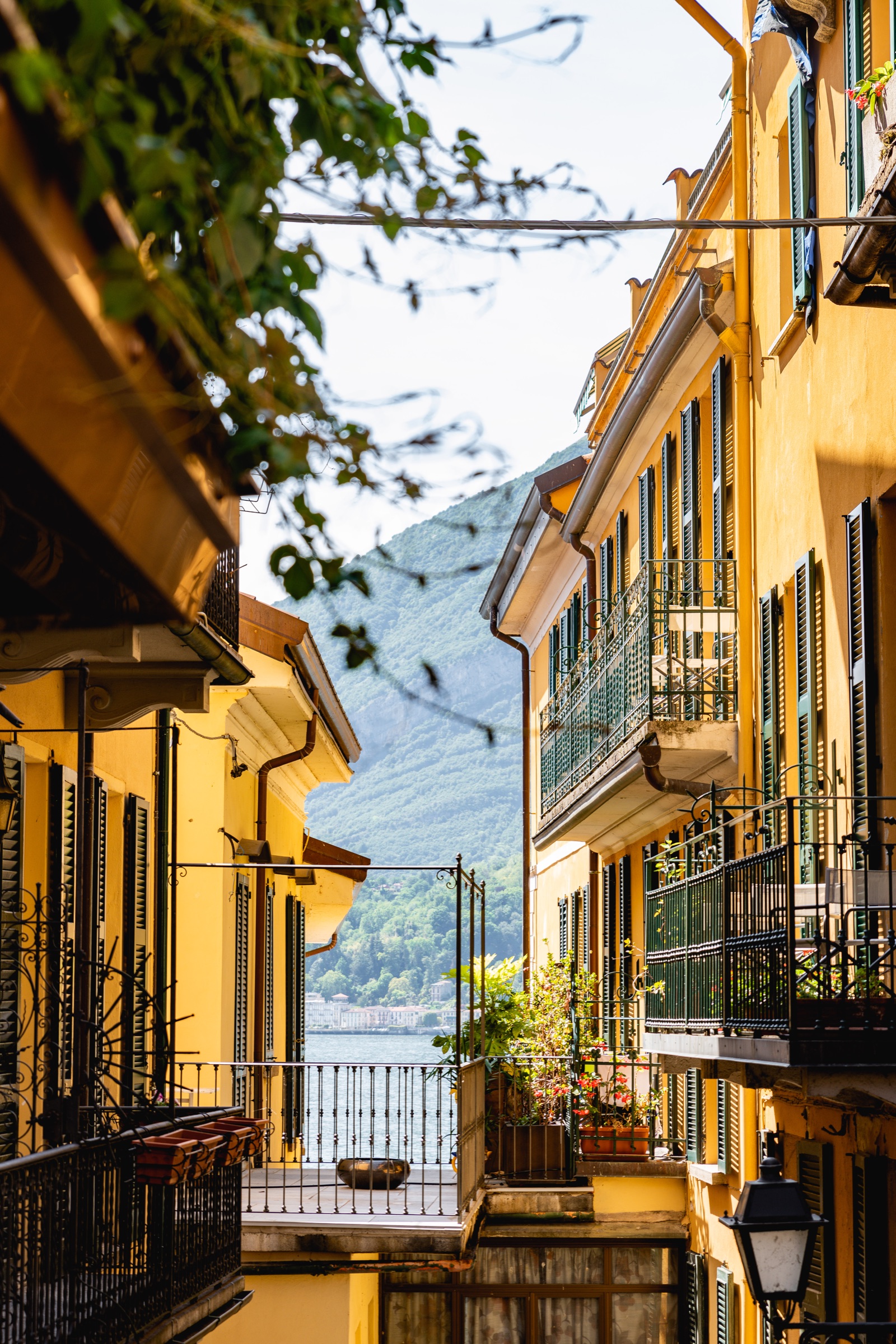 A sunlit Lake Como street opening toward the water and mountains